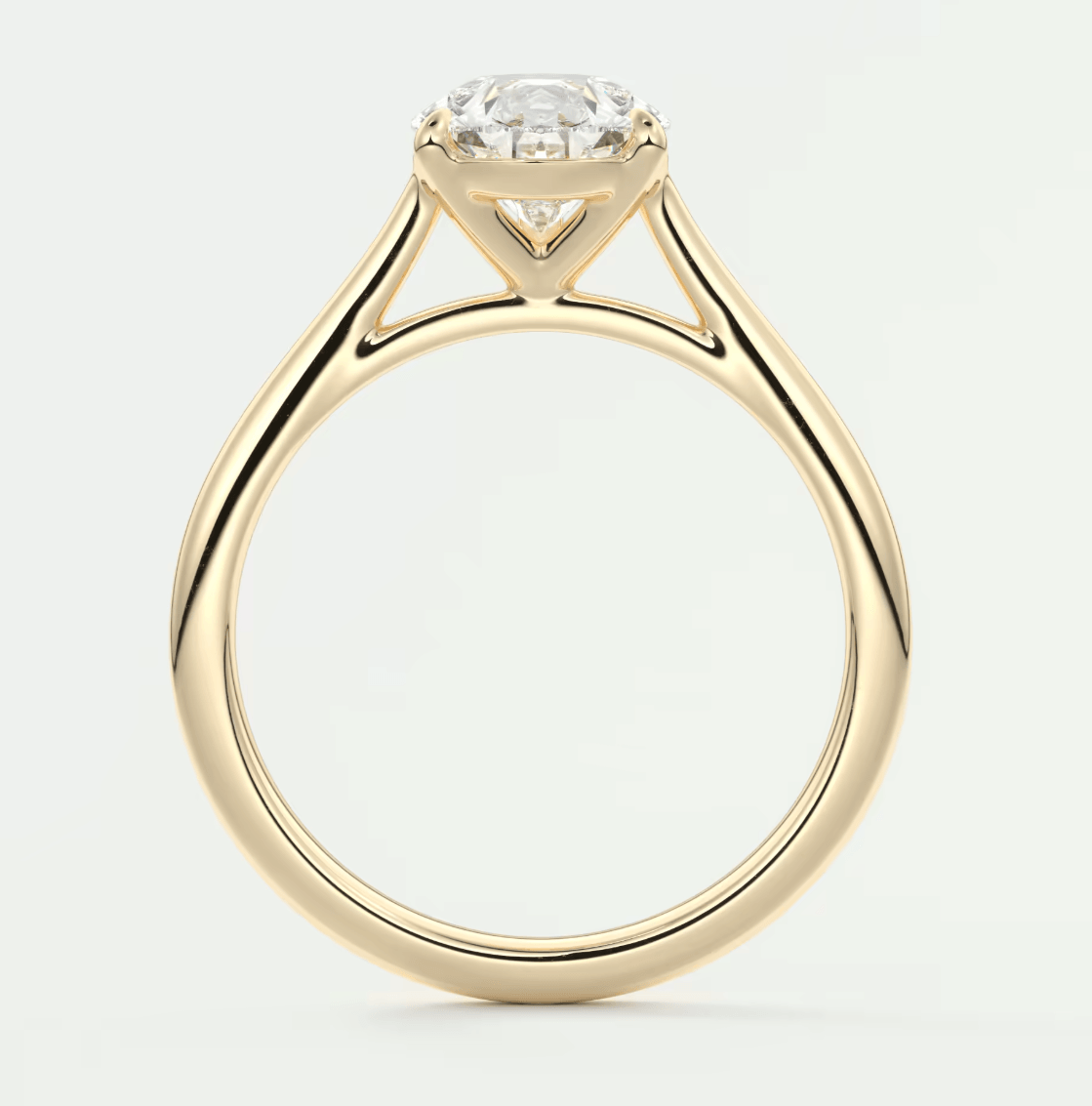 18-karat yellow gold engagement ring with a round diamond center stone.