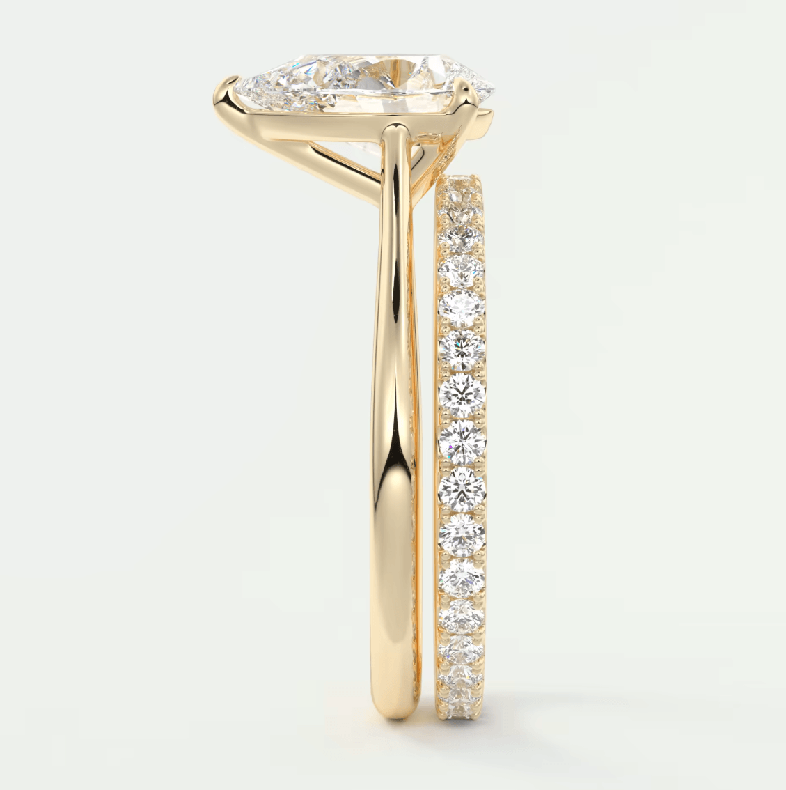 18k yellow gold diamond engagement ring with a marquise-cut center stone and channel-set diamonds on the band.