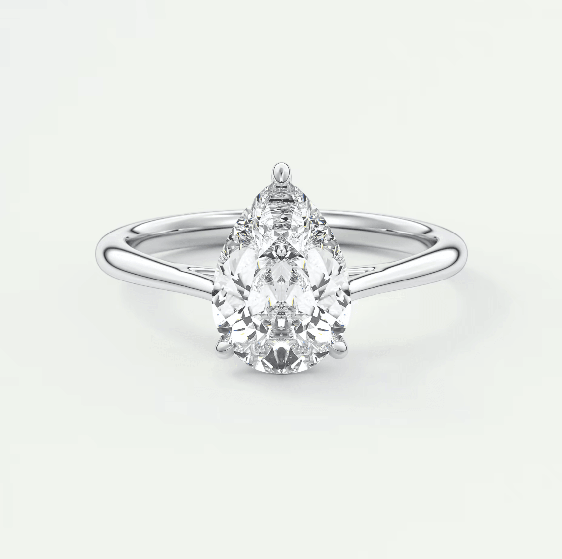 Pear-shaped diamond engagement ring with white gold band and prong setting.