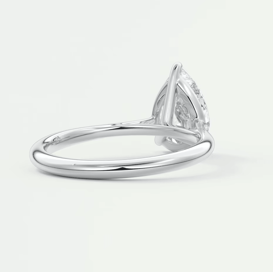 Pear-shaped diamond engagement ring with white gold band and prong setting.