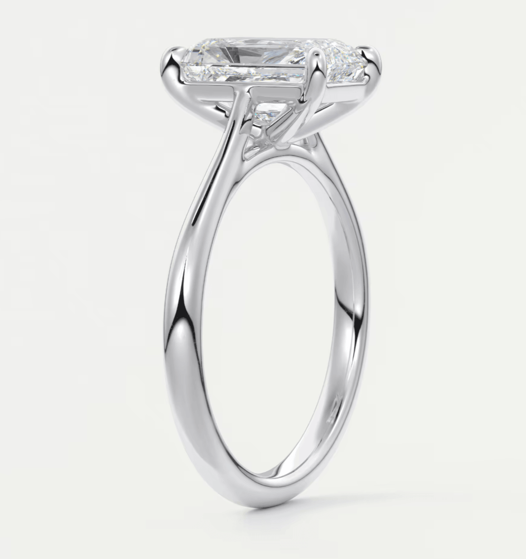White gold engagement ring with a princess cut diamond and side stones.