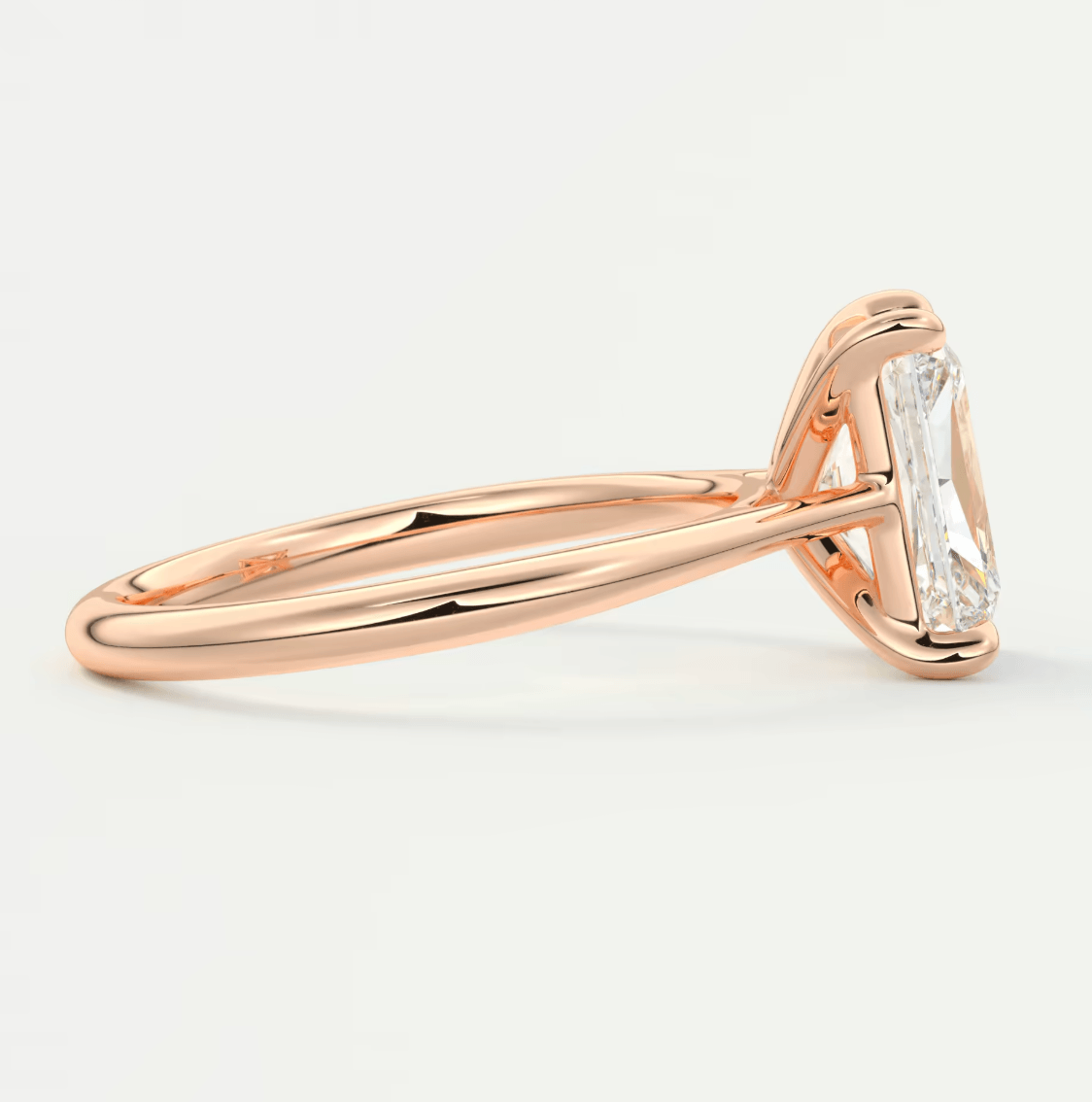18-karat rose gold engagement ring with a princess-cut diamond.
