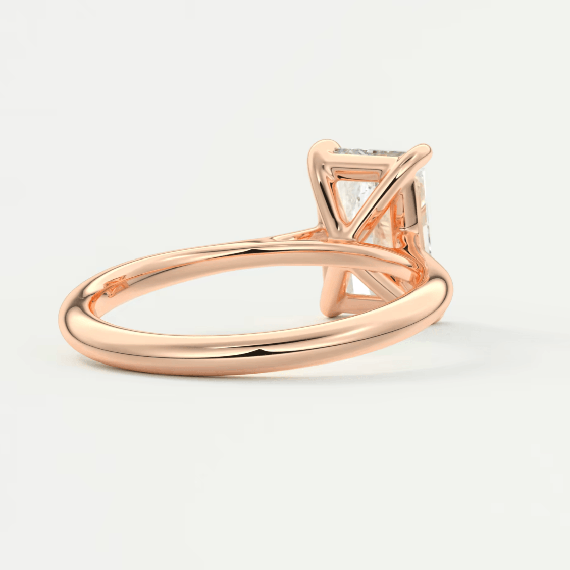 Rose gold diamond engagement ring with a princess cut gemstone.