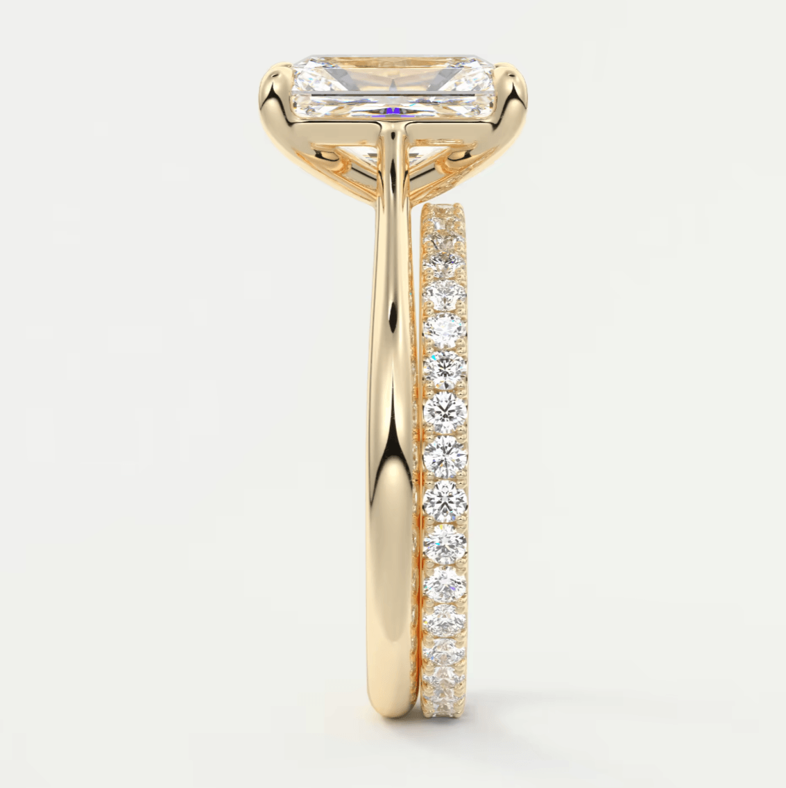 18k yellow gold engagement ring with a princess cut diamond and pave set diamonds on the band.