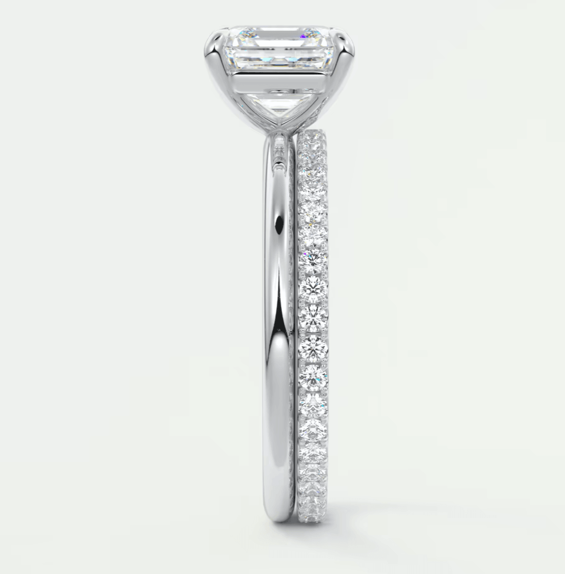 18-karat white gold engagement ring with a princess-cut diamond center stone and pavé set diamonds on the band.