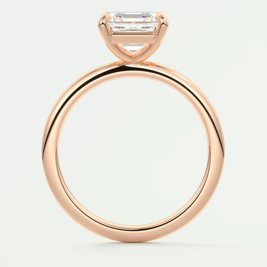 18-karat rose gold engagement ring with a baguette-cut diamond.
