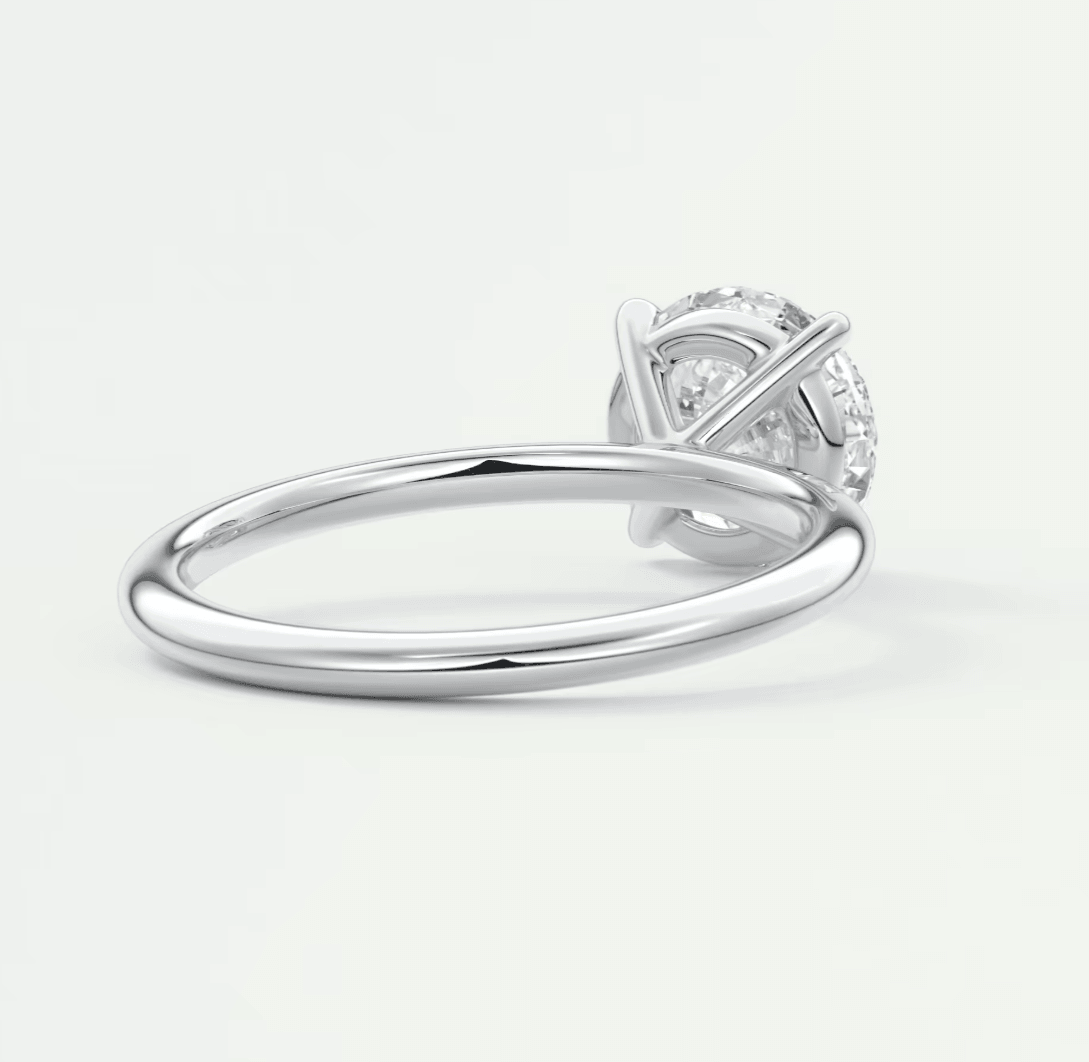 18-karat white gold diamond engagement ring with a round brilliant cut center stone and four-prong setting.