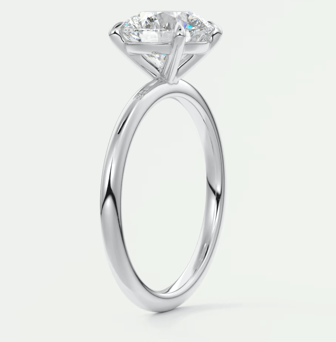 18-karat white gold solitaire diamond engagement ring with a round brilliant cut gem.