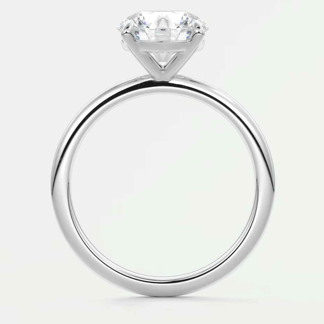 18-karat white gold solitaire engagement ring with a round diamond.