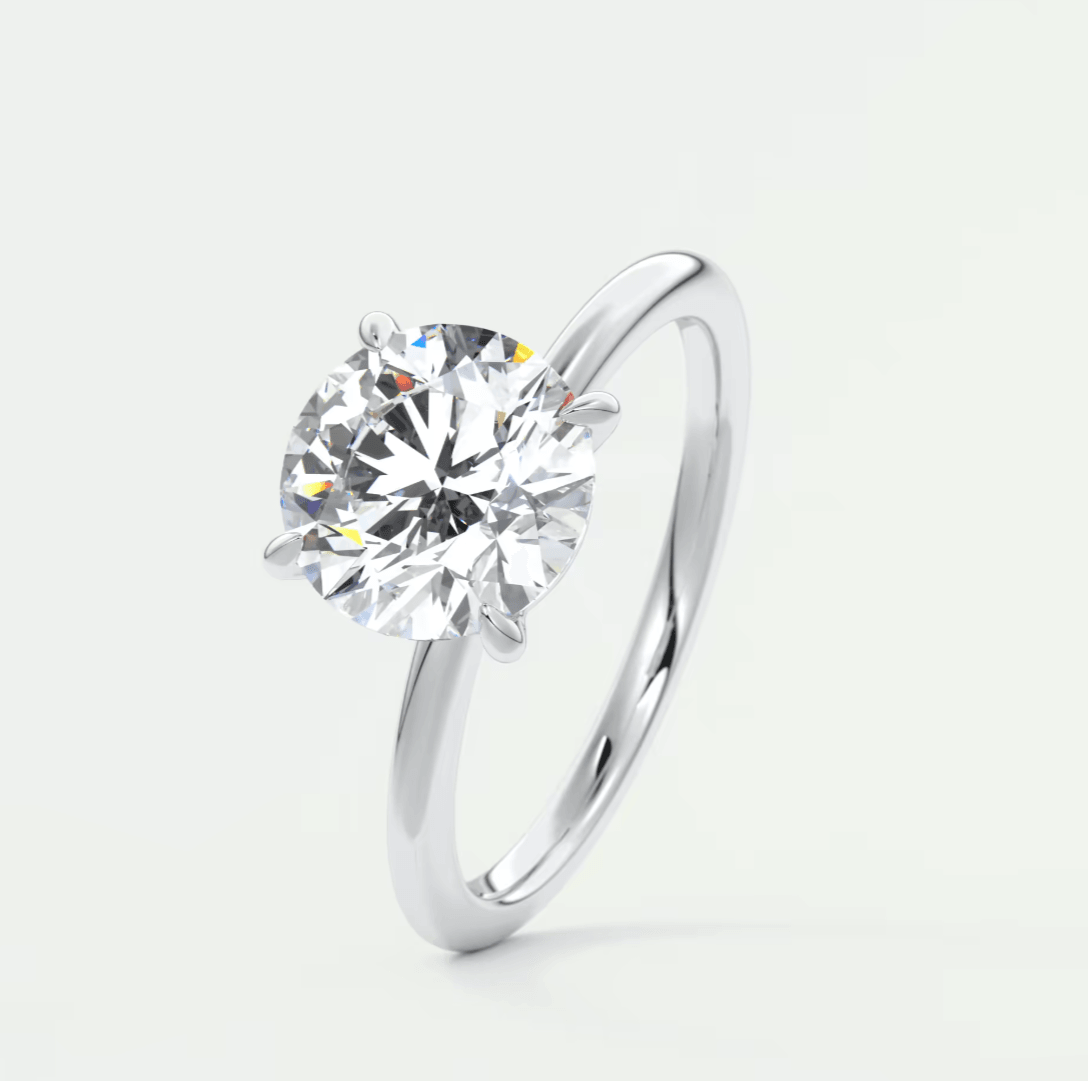 18-karat white gold solitaire diamond engagement ring with a round brilliant cut stone.
