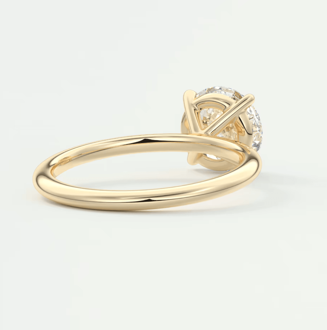 18-karat gold solitaire diamond engagement ring with a round-cut stone.