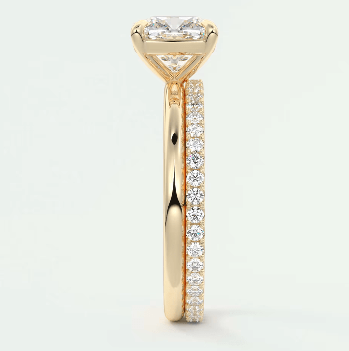 18k yellow gold engagement ring with princess cut diamond and pave set diamonds on the band.