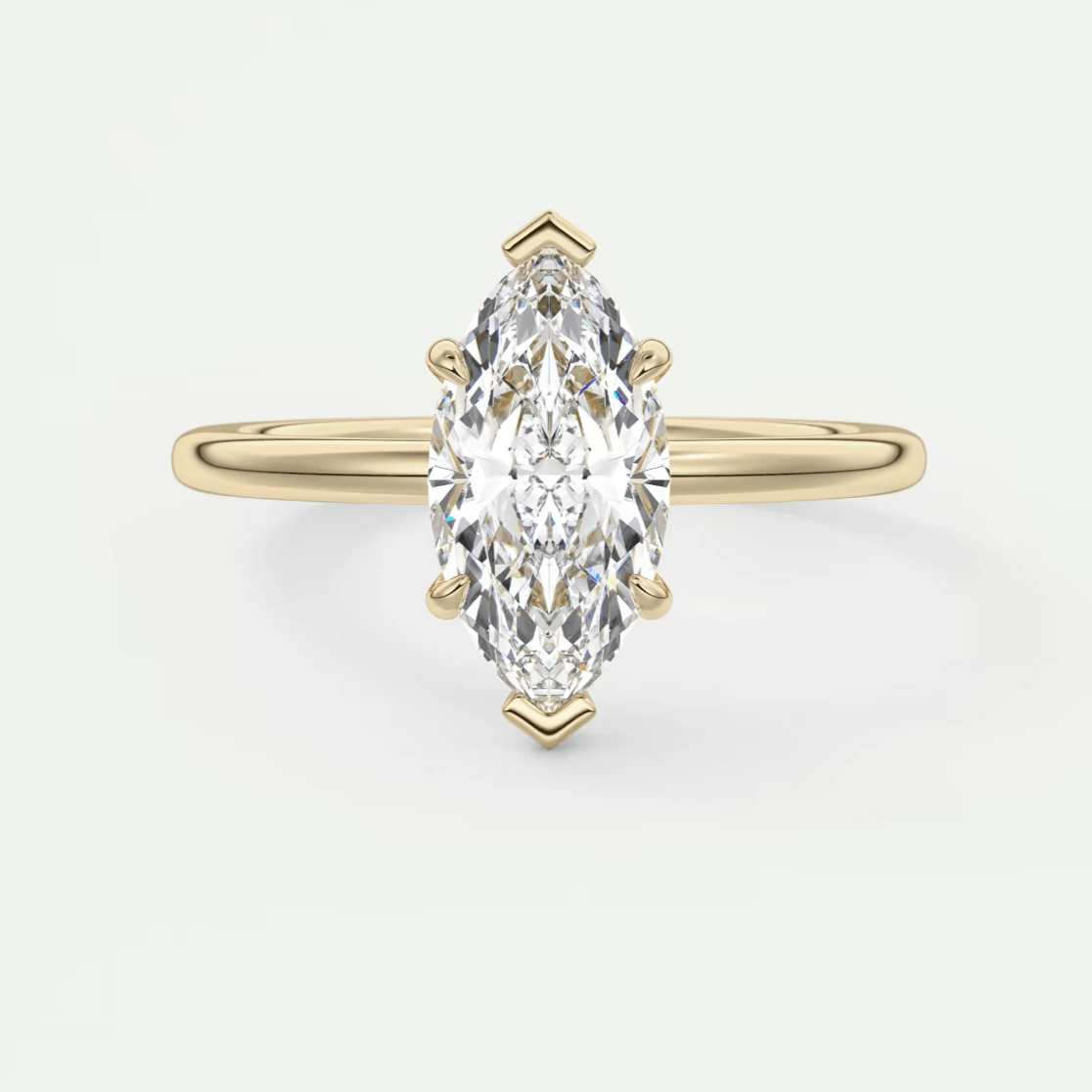 Gold marquise diamond engagement ring with a sleek band design.