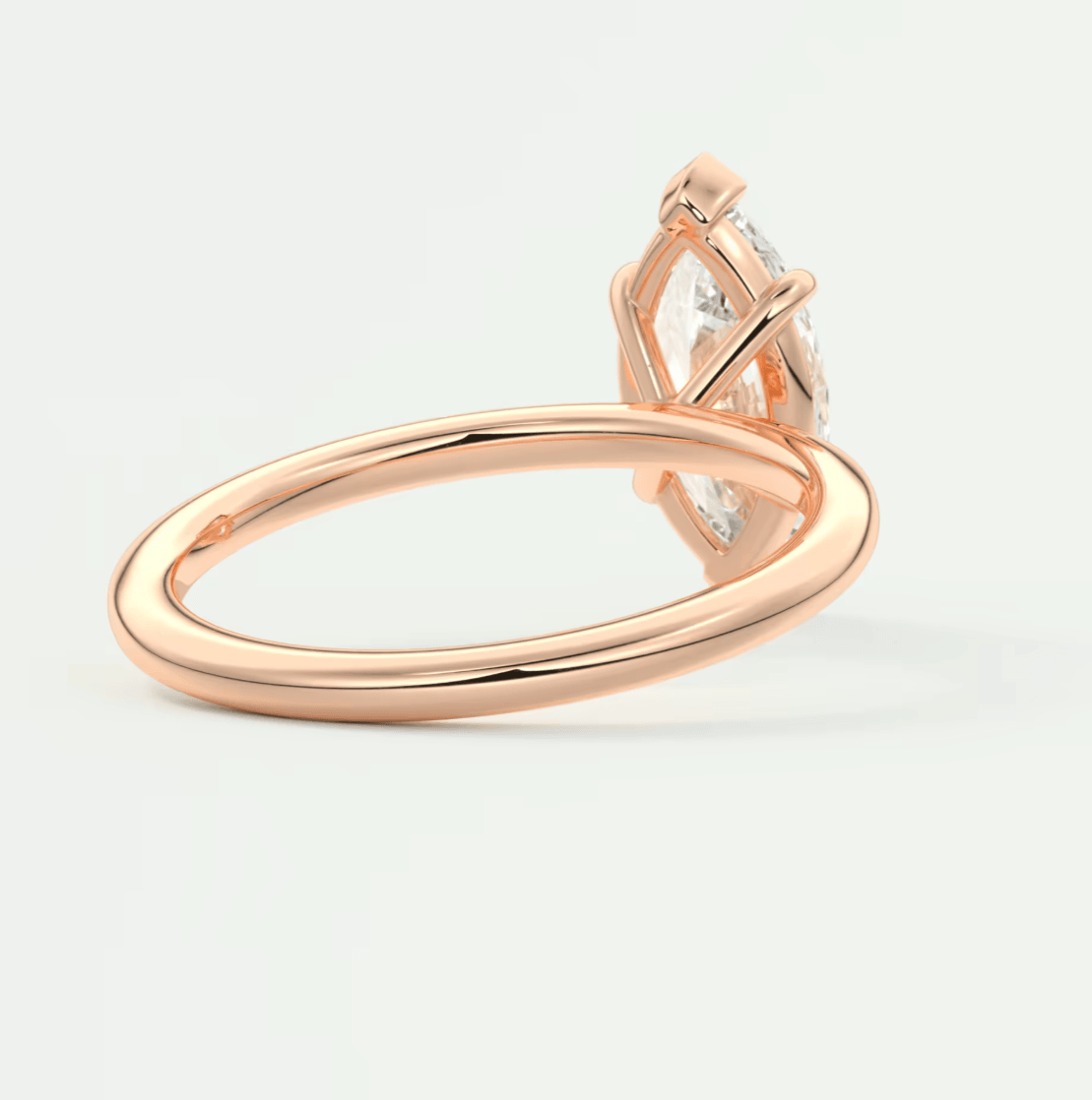 Rose gold diamond engagement ring with a marquise-cut gemstone and delicate band design.