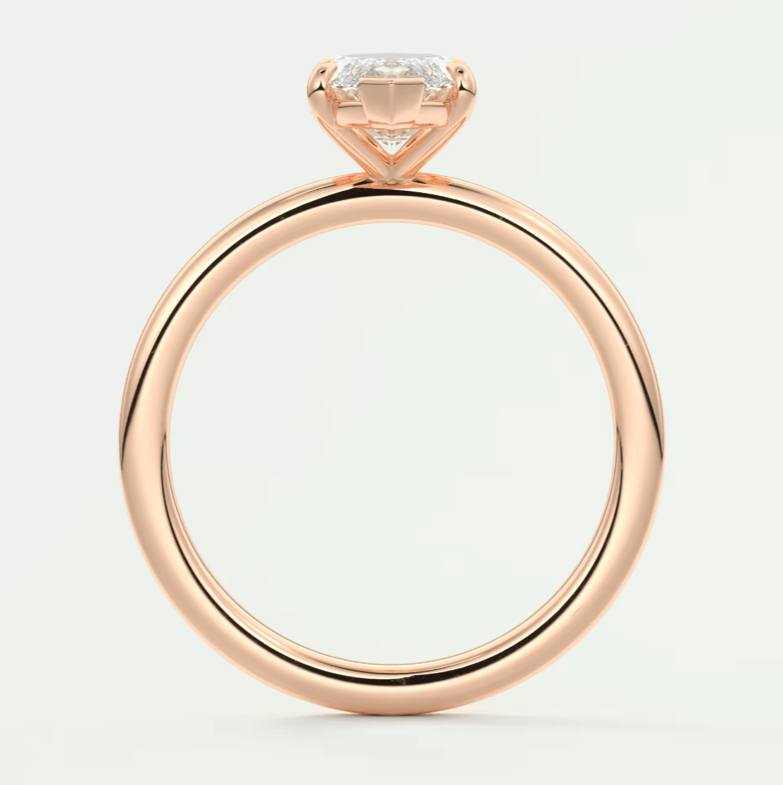 Rose gold engagement ring with a cushion-cut diamond center stone and small diamonds on the band, featuring an elegant design.