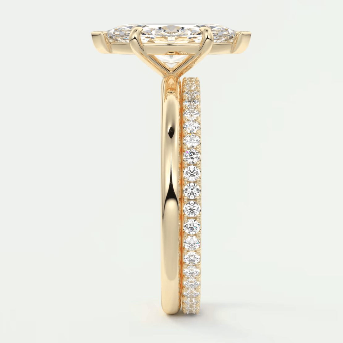 18k yellow gold diamond engagement ring with a marquise-cut center stone and pave set diamonds on the band.