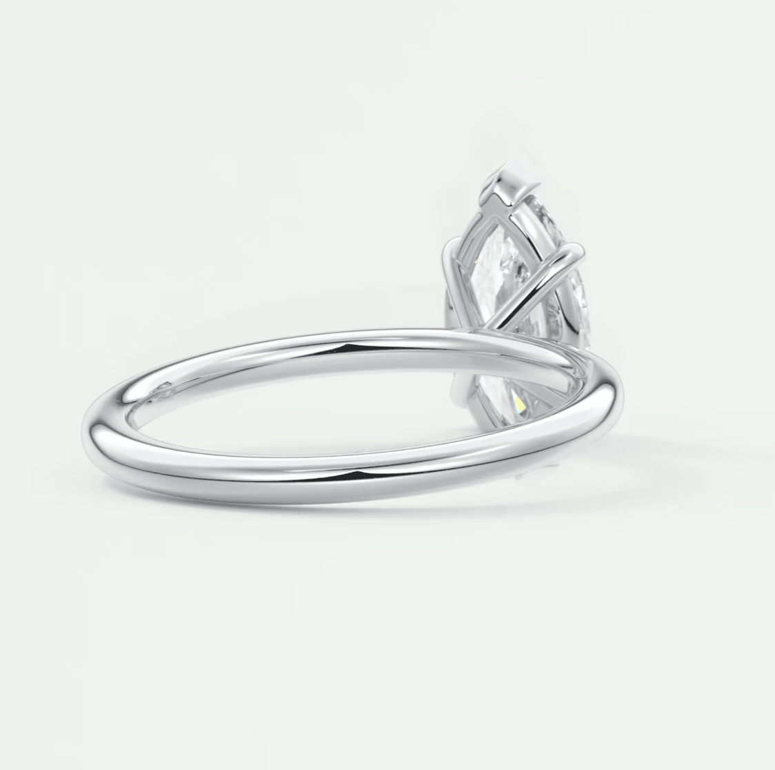 Silver marquise diamond engagement ring with leaf design.