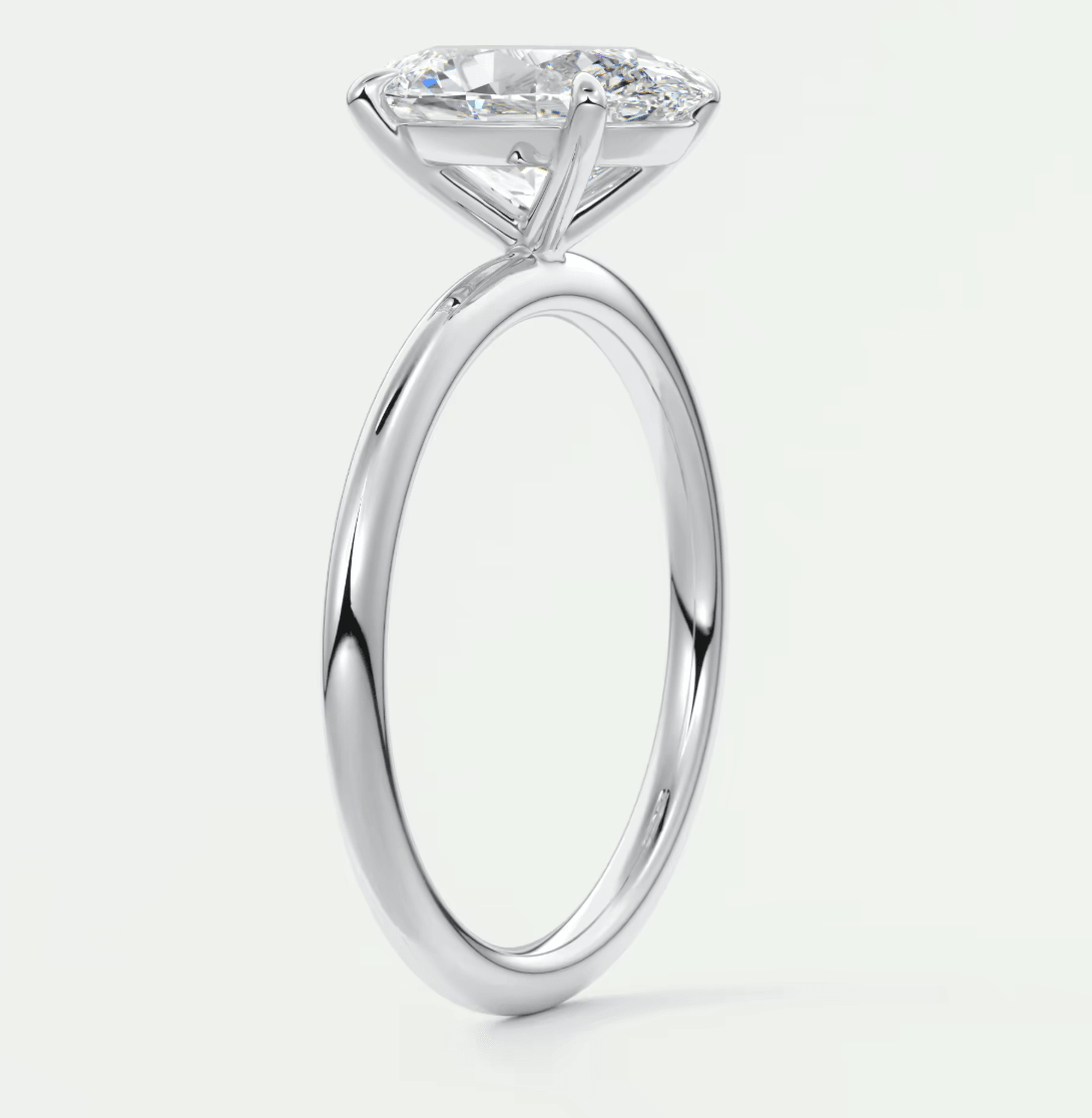 18-karat white gold solitaire engagement ring with a round diamond.