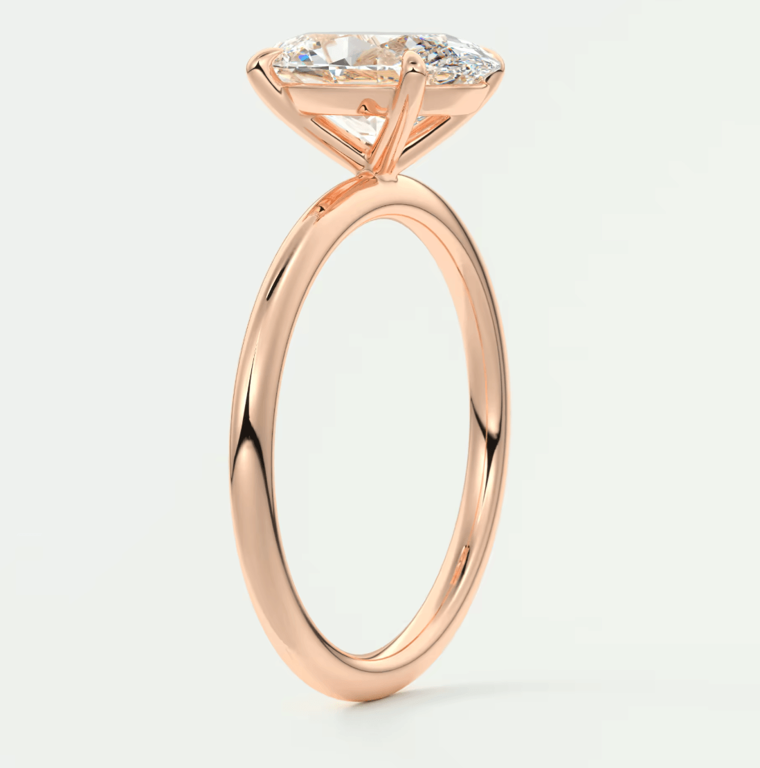 18-karat rose gold engagement ring with a marquise-cut diamond.