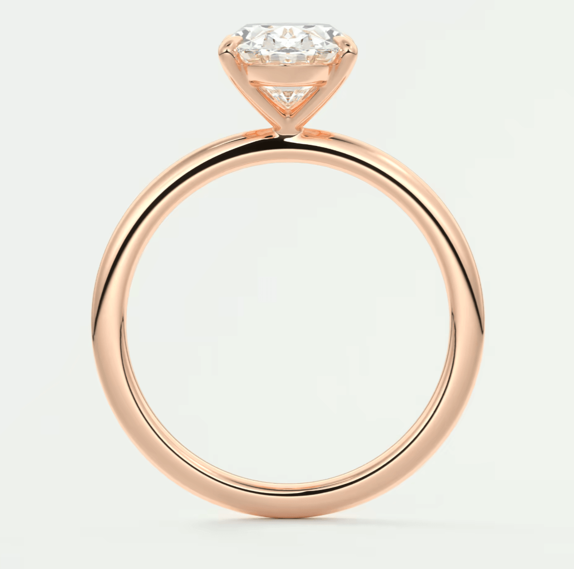 Rose gold diamond engagement ring with a cushion-cut center stone and delicate band design.