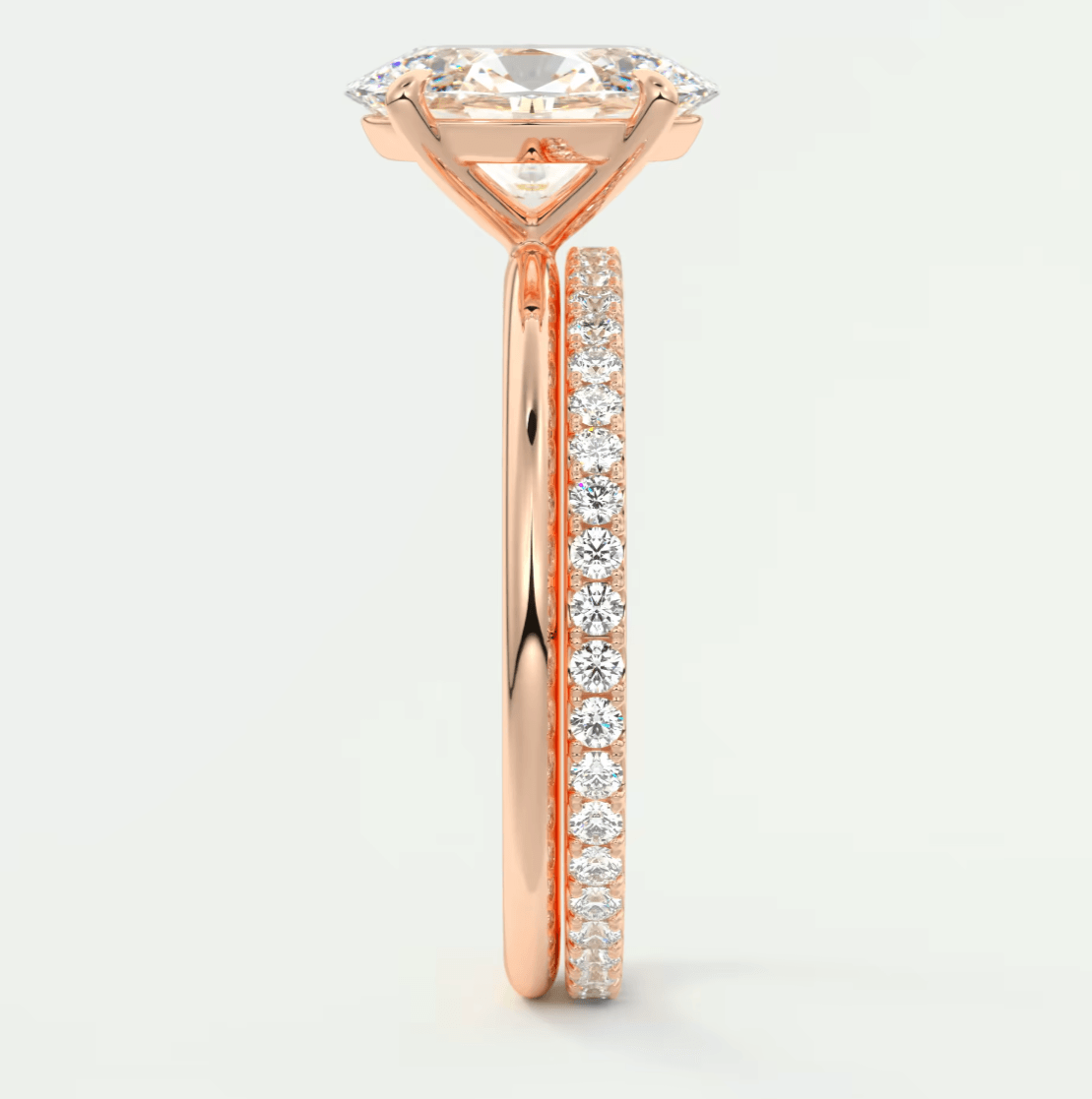 18-karat rose gold engagement ring with a princess-cut diamond and pavé side stones.