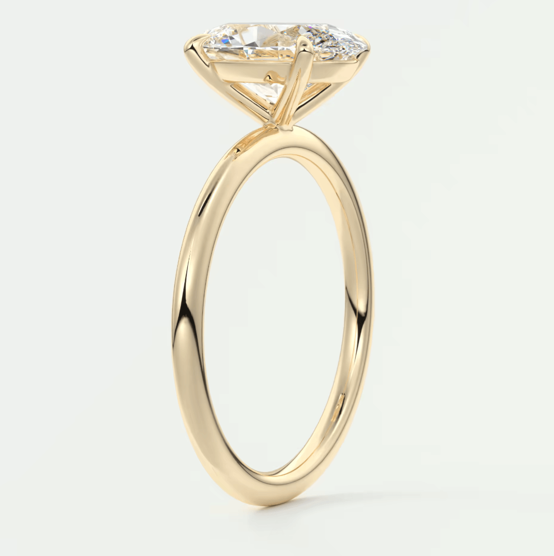 18k yellow gold solitaire engagement ring with a cushion-cut diamond.