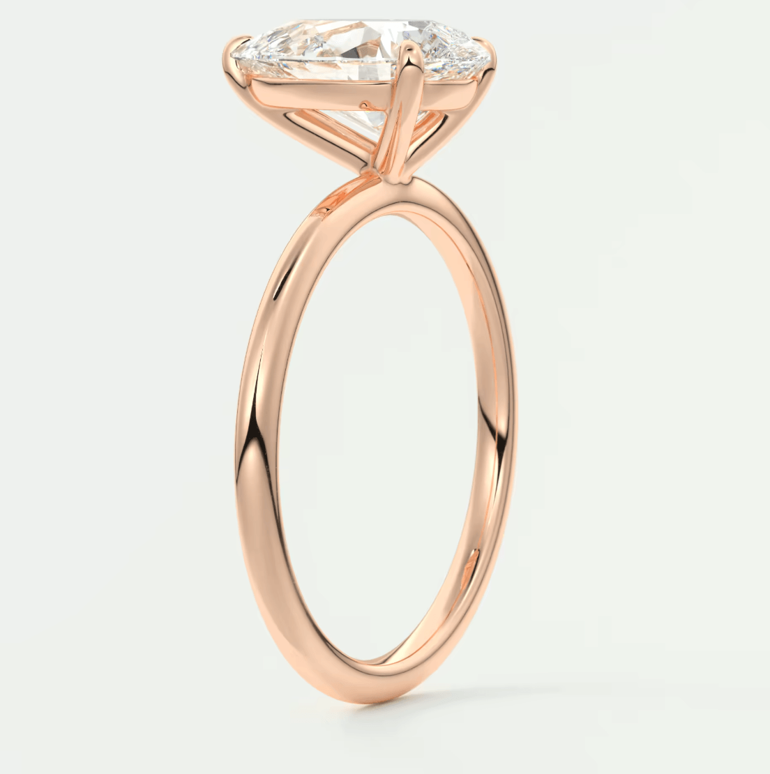 18k rose gold engagement ring with a marquise-cut diamond.