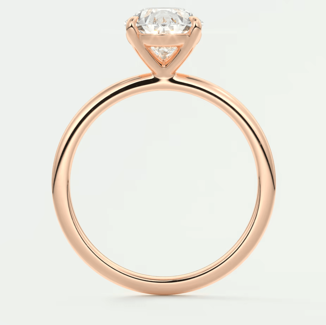 Rose gold engagement ring with a cushion-cut diamond center stone.
