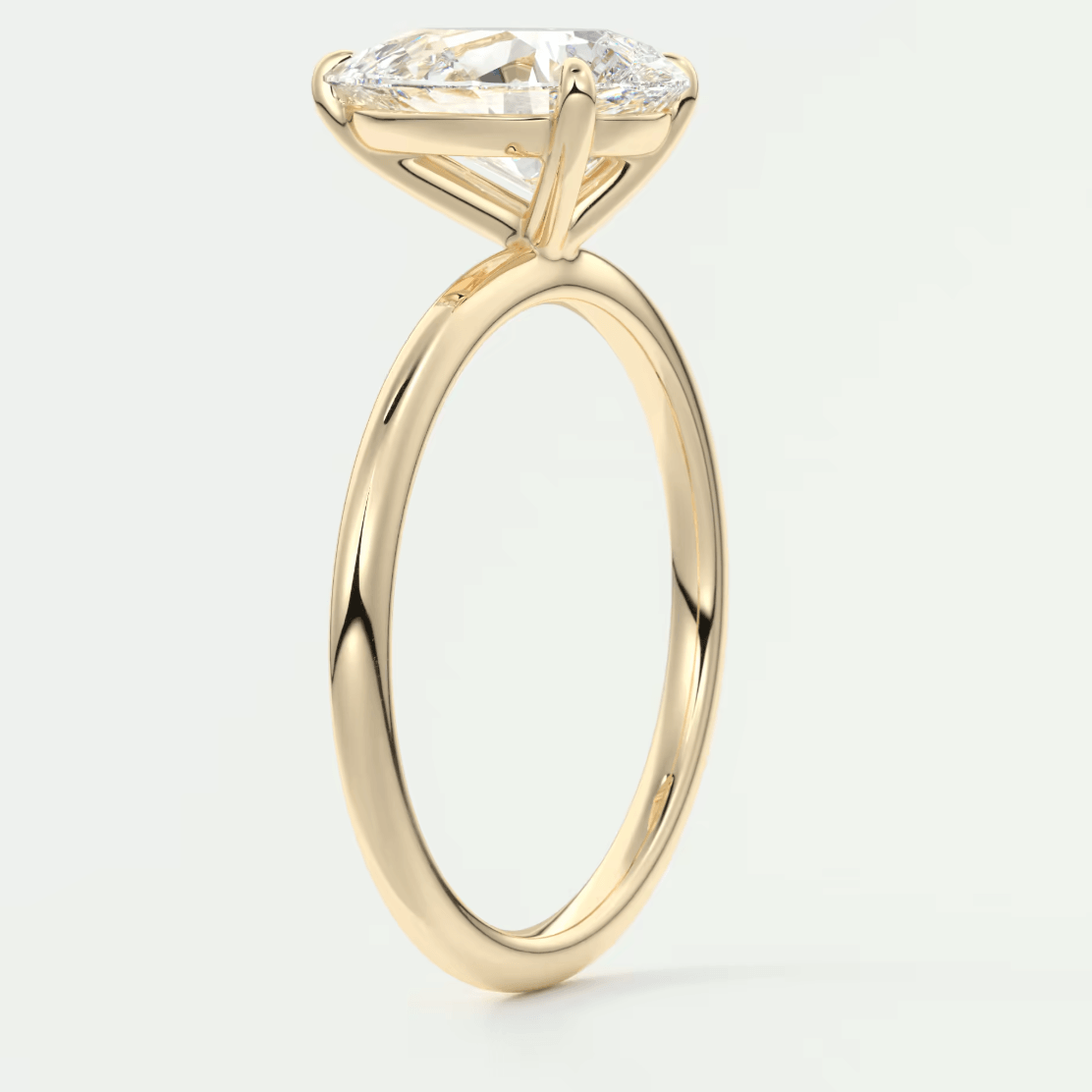 18-karat yellow gold engagement ring with a marquise-cut diamond.