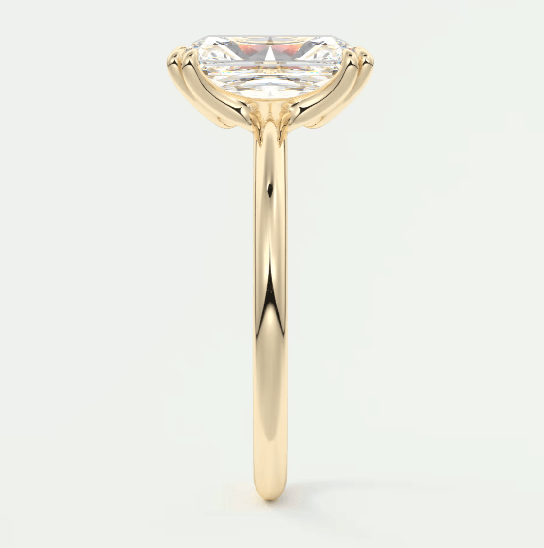 18k yellow gold engagement ring with a marquise-cut diamond.