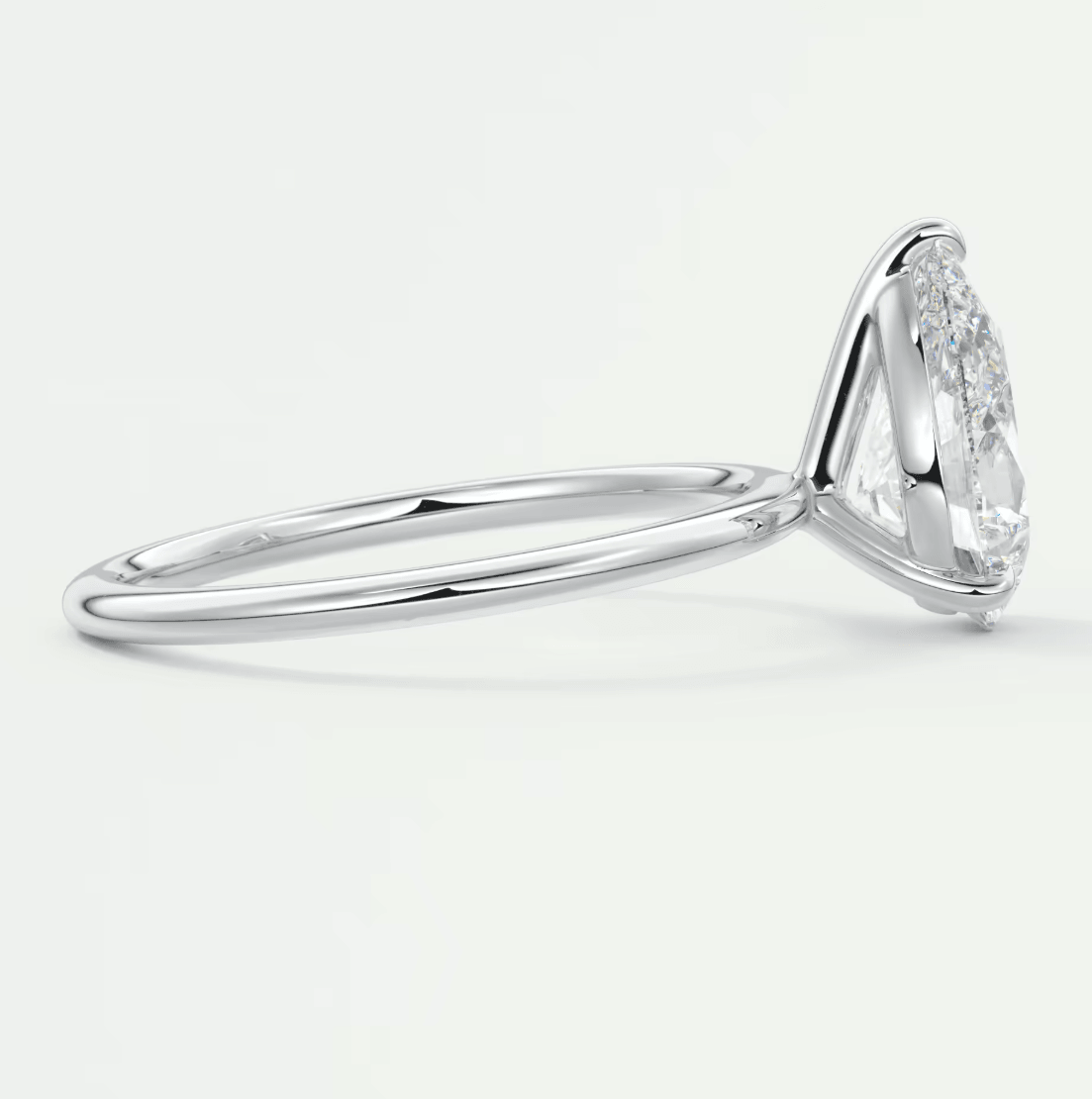 18k white gold engagement ring with marquise diamond and pavé side stones.