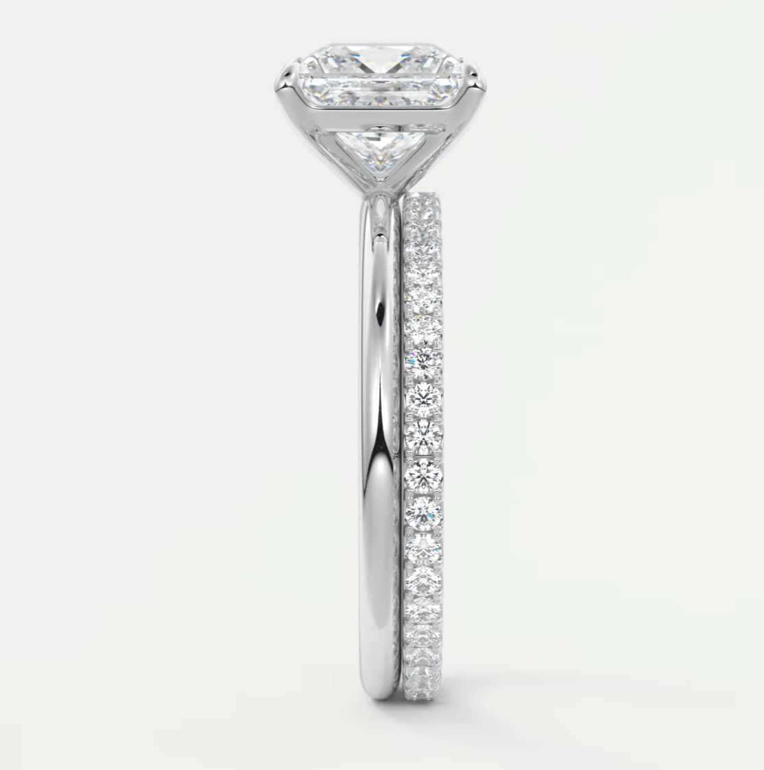 18-karat white gold engagement ring with a princess-cut diamond and pave-set diamonds on the band.