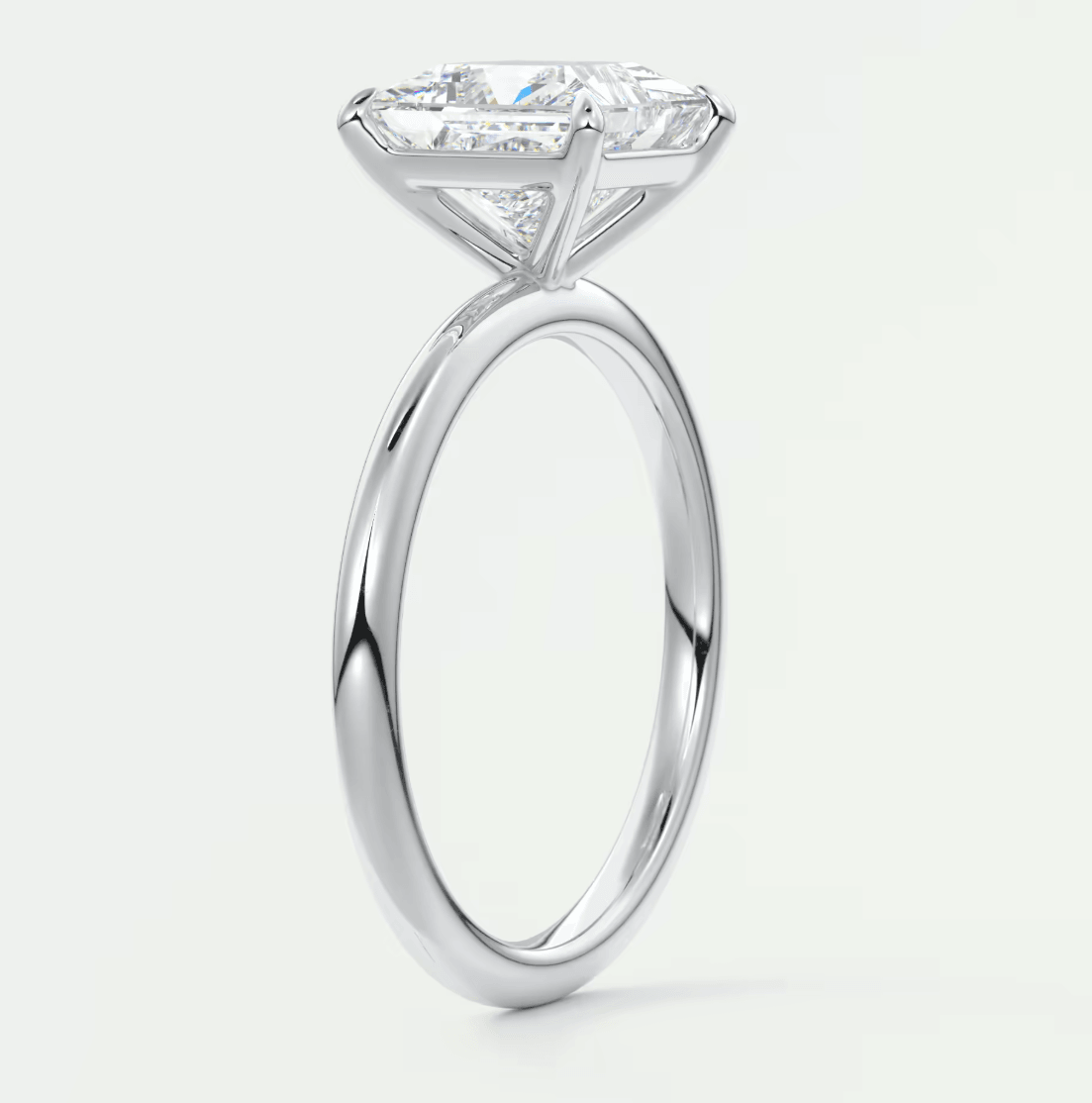 18-karat white gold engagement ring with a princess-cut diamond.