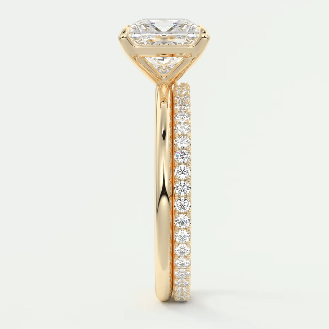 18k yellow gold engagement ring with princess cut diamond and pave set diamonds on the band.