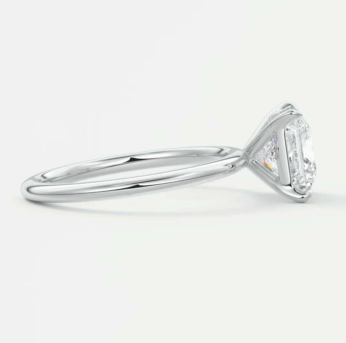 18k white gold engagement ring with a princess cut diamond and baguette side stones.