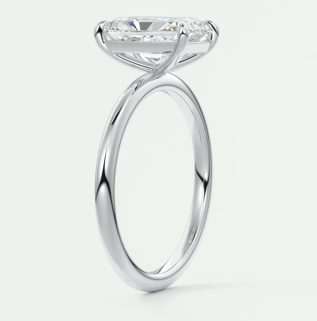 18-karat white gold engagement ring with a cushion-cut diamond.