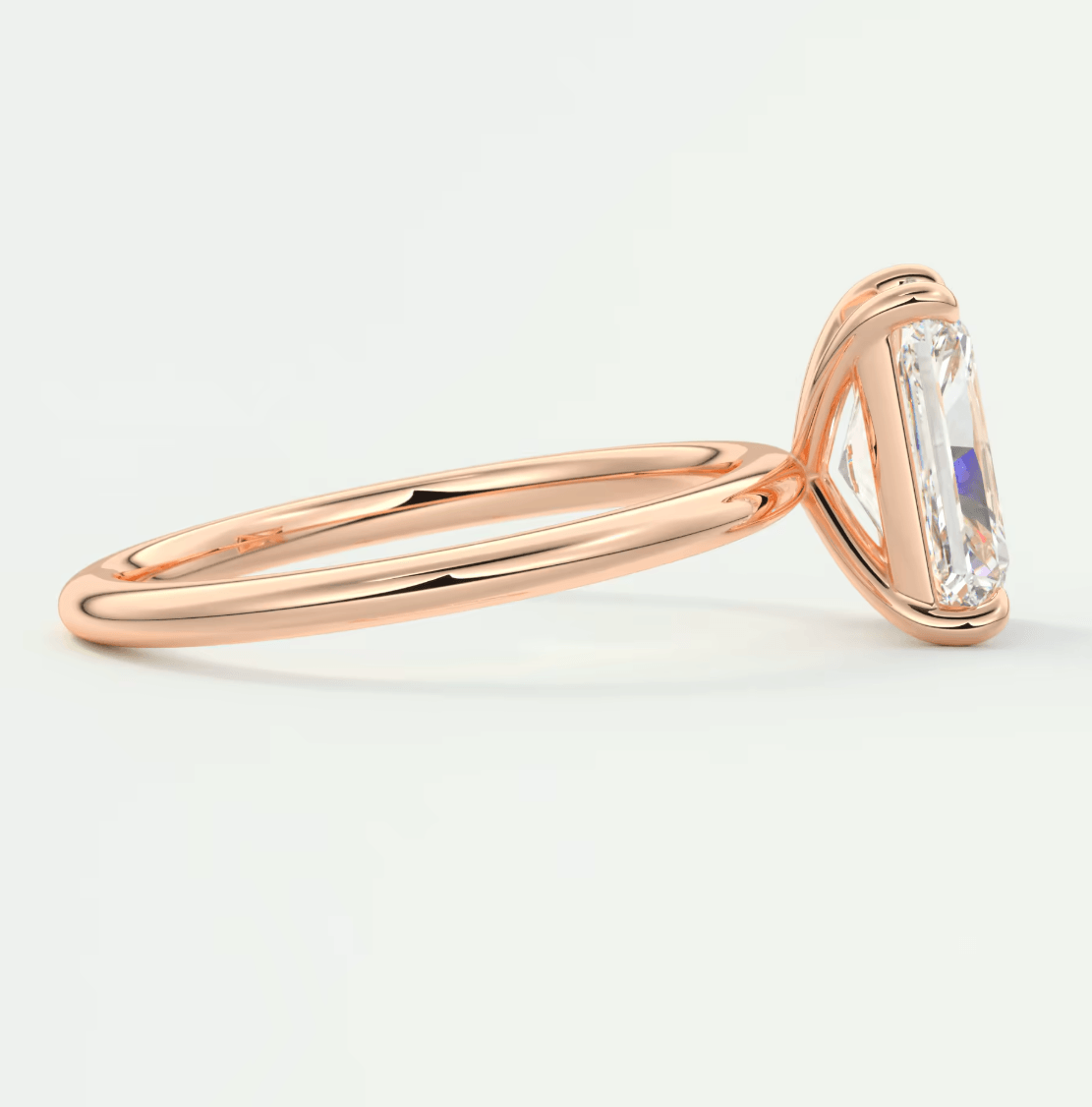 18-karat rose gold engagement ring with an emerald-cut diamond.