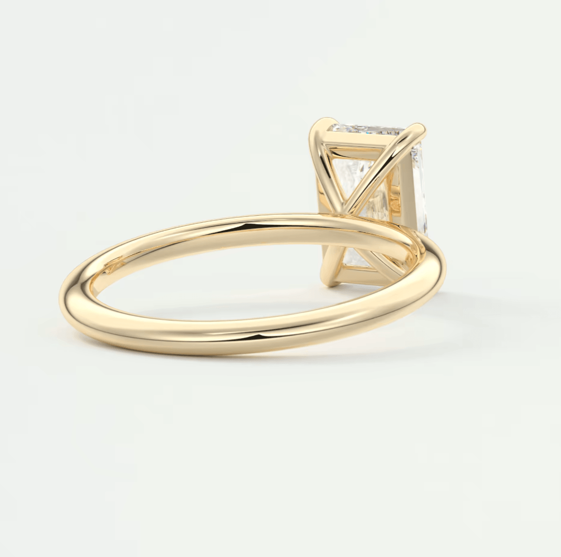 18k yellow gold engagement ring with a princess cut diamond.