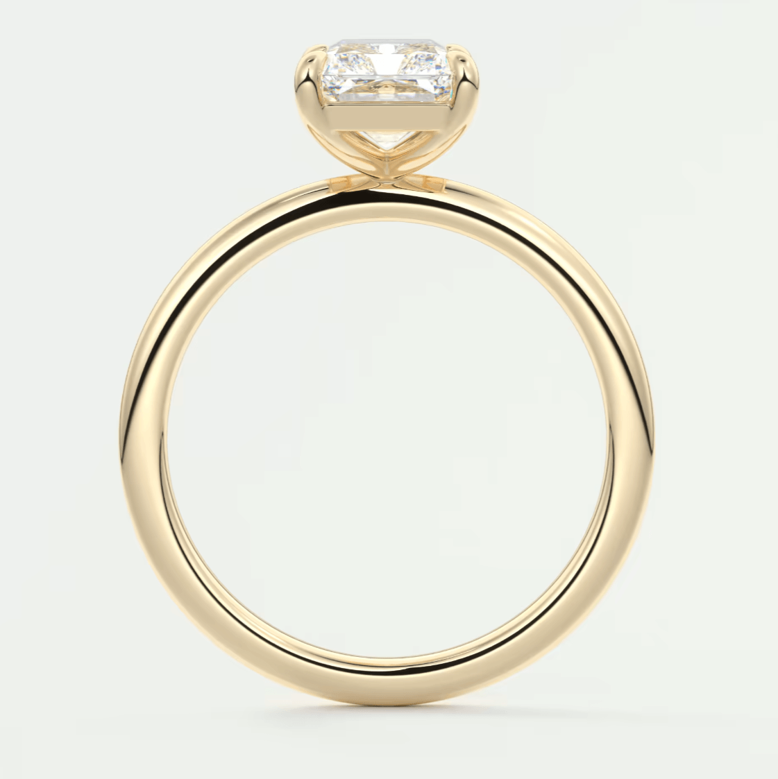 18-karat yellow gold engagement ring with a rectangular diamond.