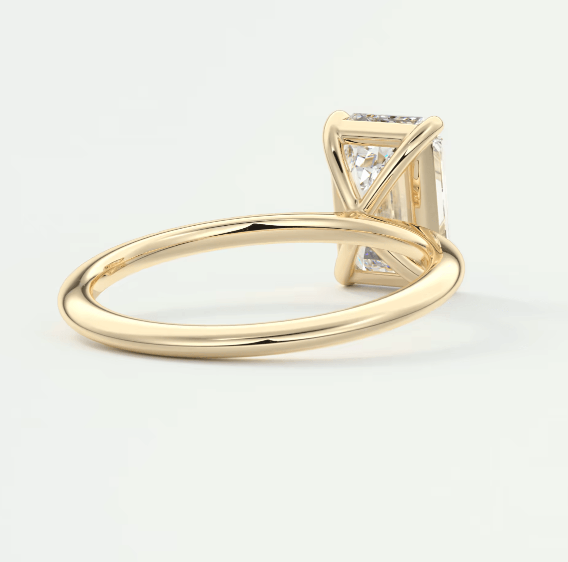 18k yellow gold princess cut diamond engagement ring with a halo of smaller diamonds.