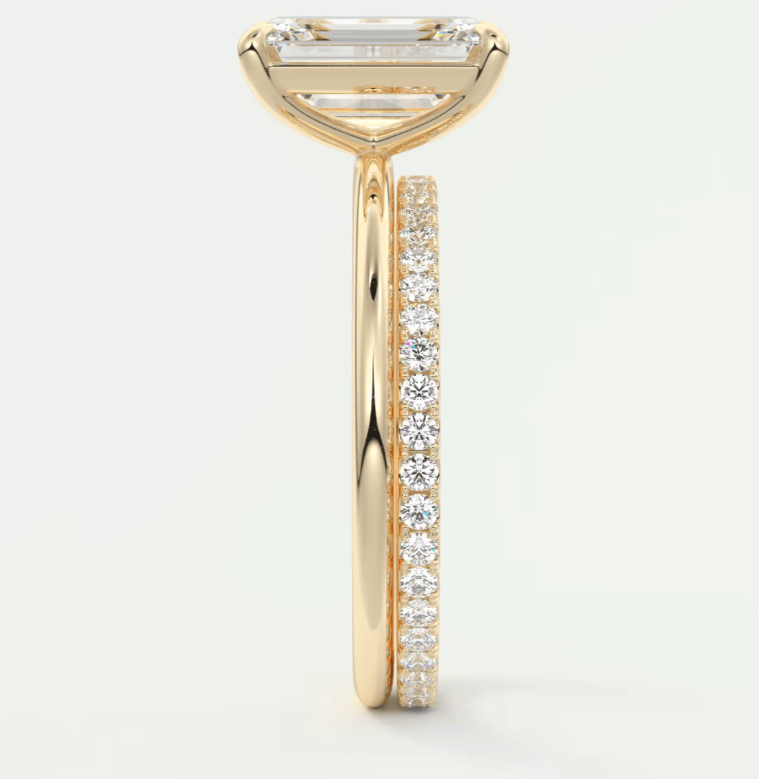 18k yellow gold engagement ring with a princess cut diamond and pave set diamonds on the band.