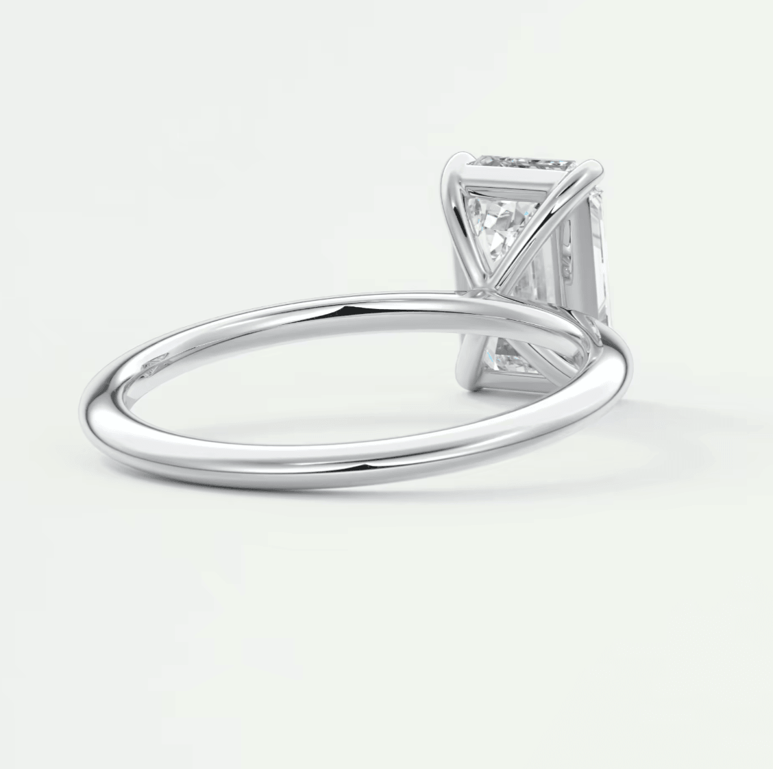 18k white gold diamond engagement ring with a princess cut center stone and pave set diamonds on the band.