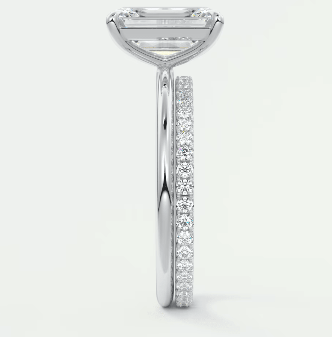 18k white gold diamond engagement ring with a princess cut center stone and pave set diamonds on the band.