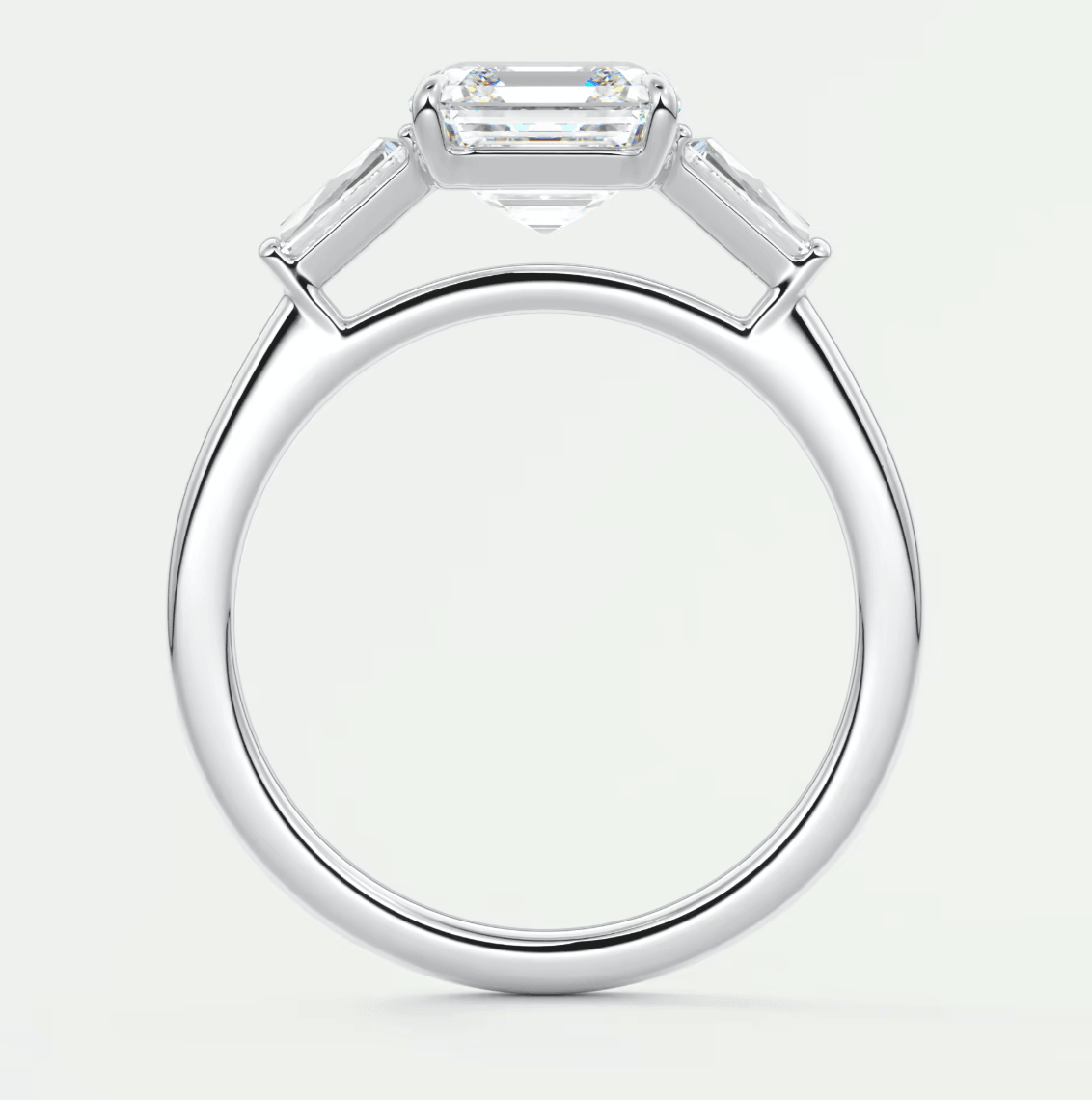 18k white gold emerald-cut diamond engagement ring with baguette accents.