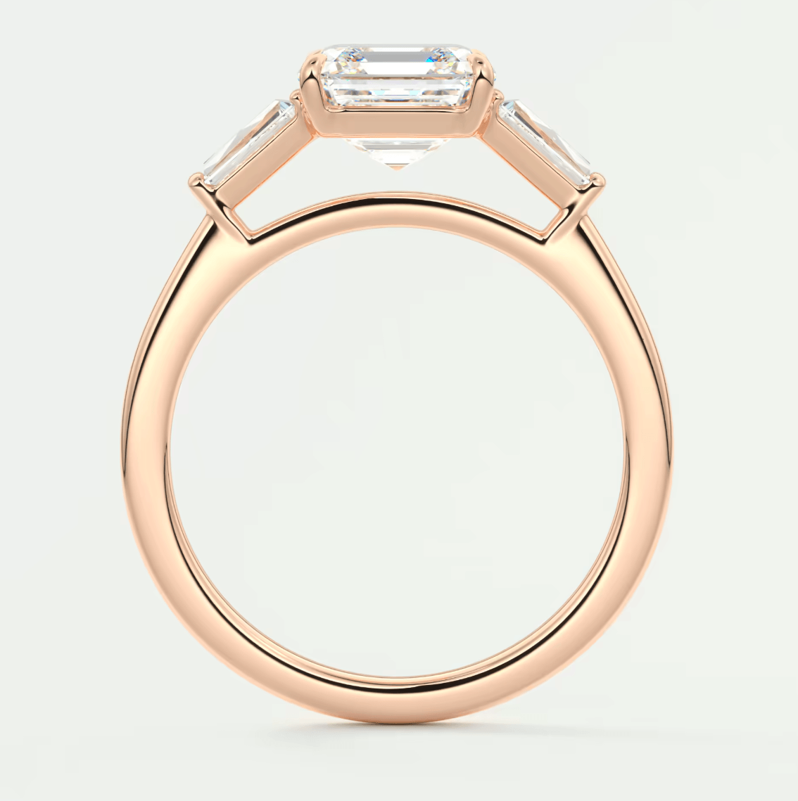 18-karat rose gold engagement ring with an emerald-cut diamond.