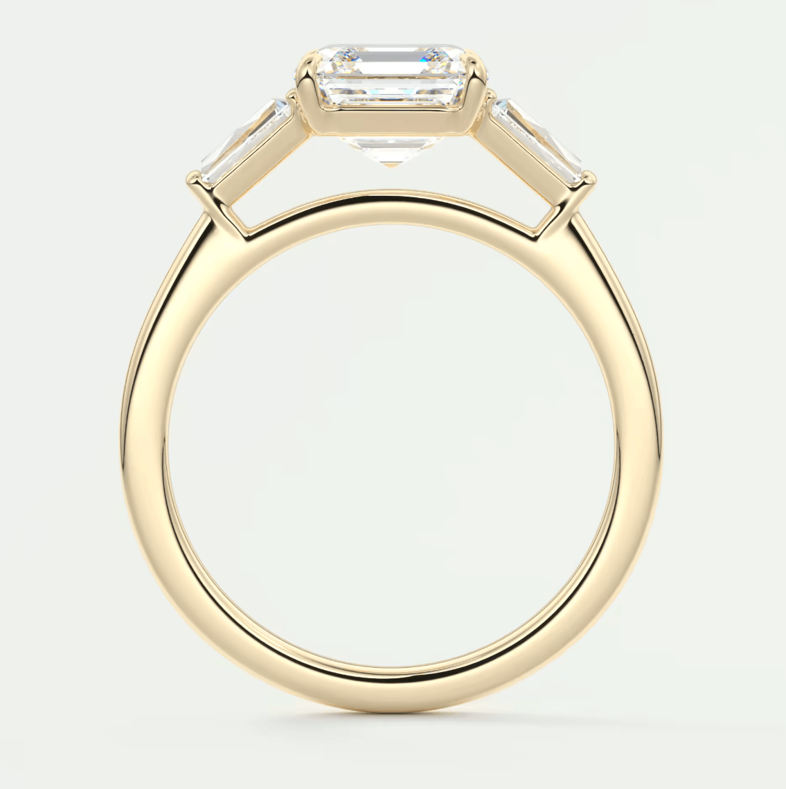 18k yellow gold emerald cut diamond engagement ring with a bezel setting.