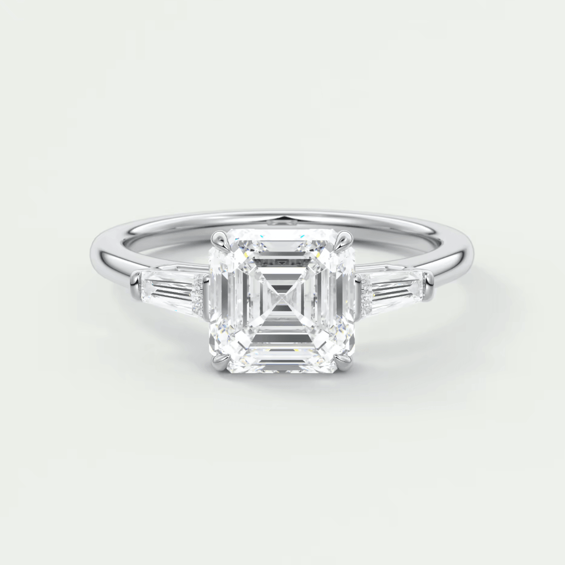 18k white gold emerald cut diamond engagement ring with baguette side stones.