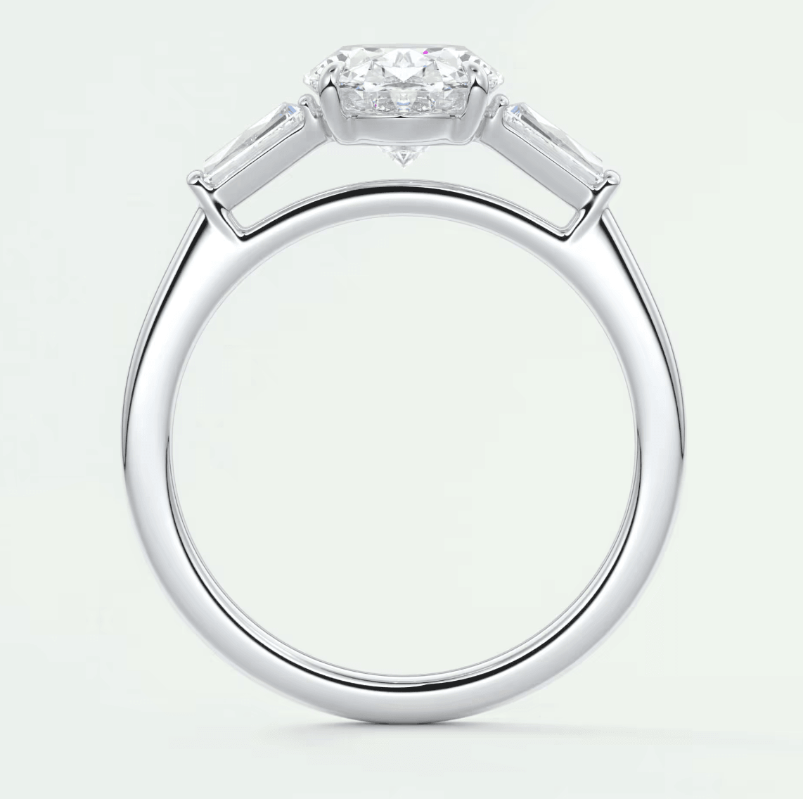 18k white gold diamond engagement ring with a cushion-cut center stone and baguette side stones.