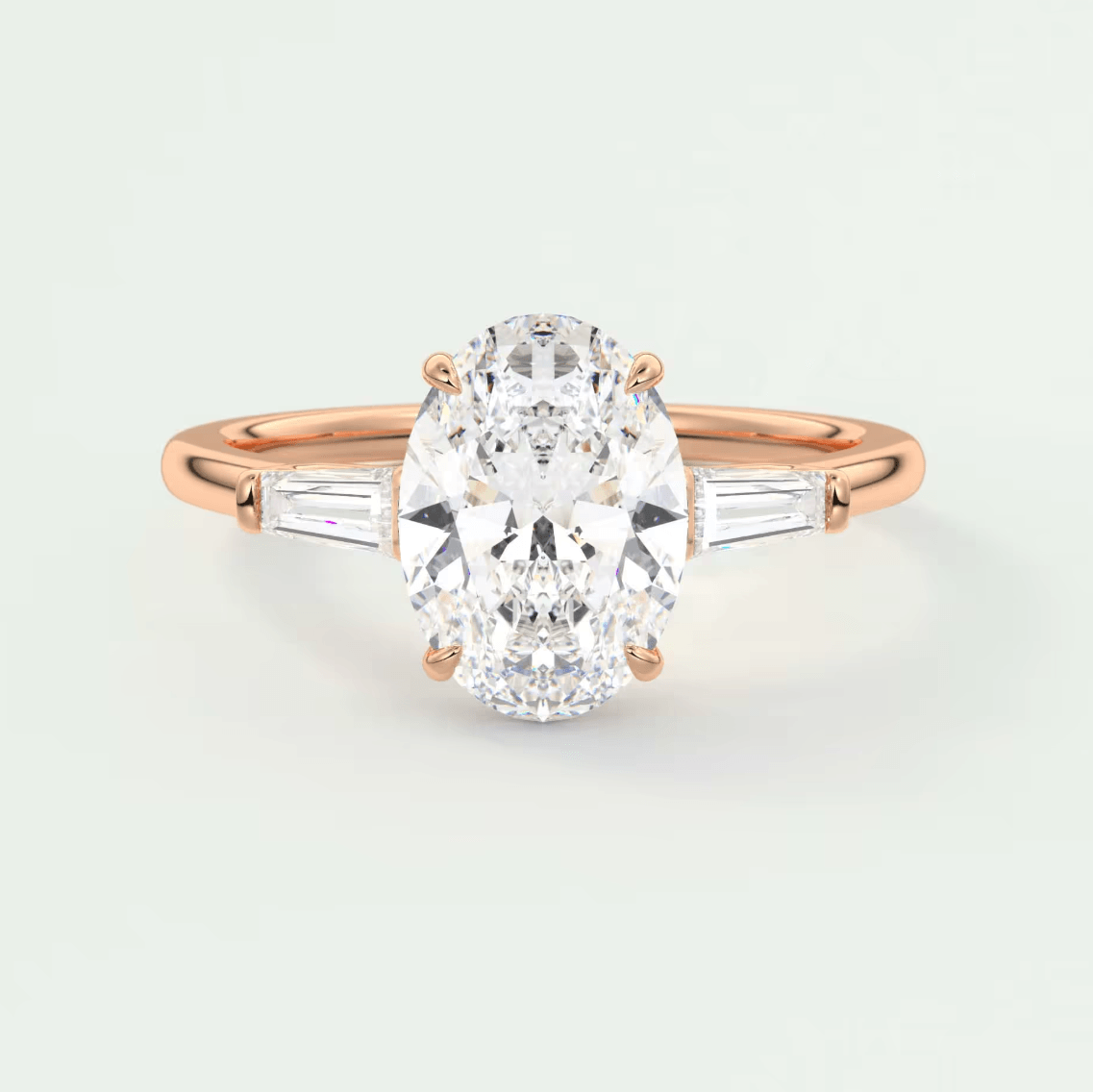18k rose gold diamond engagement ring with an oval-cut center stone and baguette side stones.