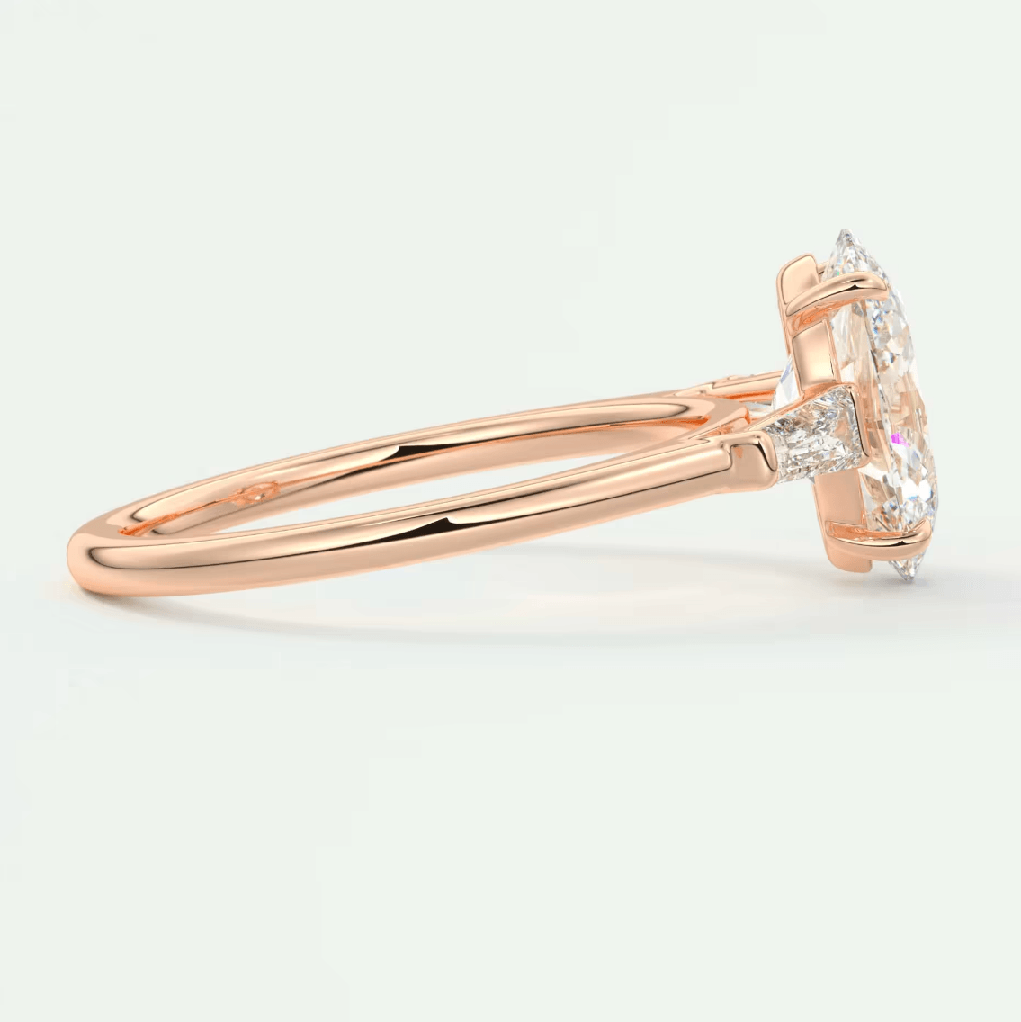 18-karat rose gold engagement ring with a marquise-cut diamond and smaller accent diamonds.